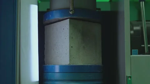 Concrete block breaks under high pressure . Compressive strength test Stock Footage 153050965