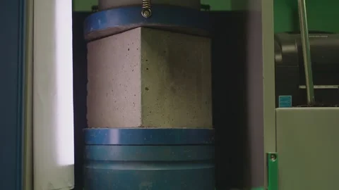 Concrete block breaks under high pressure . Compressive strength test Stock Footage 153050995