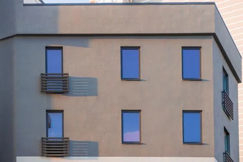 Concrete block building frame facade gray cement and windows decorative balco Fotos de archivo