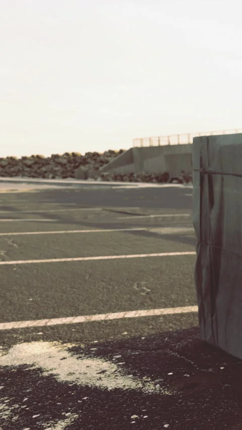 Concrete block sits on empty parking lot near the coast in the afternoon Stock-Footage 336581803