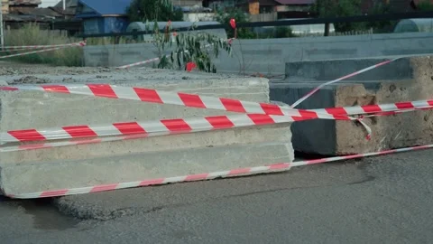 Concrete blocks block the road and passage. Warning tapes signal danger. Stock Footage 280772831