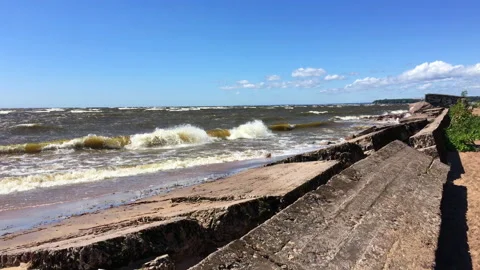 Concrete blocks on the sandy beach. Gulf of Finland Stock Footage 207681936