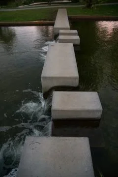 Concrete blocks in small river stream Stock Photos