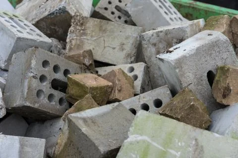 Concrete bricks construction material laying in skip on each other heap Stock Photos
