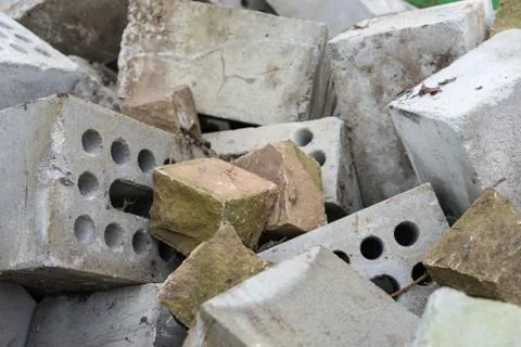 Concrete bricks construction material laying in skip on each other heap Stock Photos