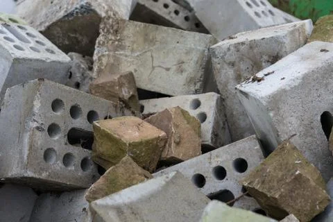 Concrete bricks construction material laying in skip on each other heap Stock Photos