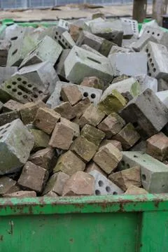 Concrete bricks construction material laying in skip on each other heap Stock Photos