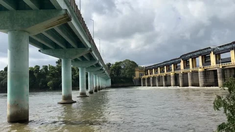 Concrete Bridge and Dam Barrage Over River under Cloudy Sky Stock Footage 342542322