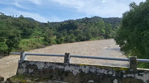 Concrete bridge crossing over a shallow rocky river Stock Footage 337050270
