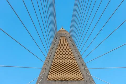 Concrete bridge pylon with parallel lines of steel cable. Stock Photos