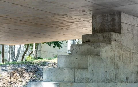 Concrete bridge structure with pillars and stairs under overpass, raw cemen.. Stock Photos