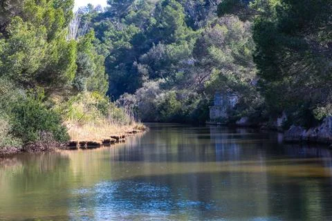Concrete bridge structure spanning natural river landscape Stock Photos