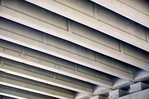Concrete bridge underside featuring repeating diagonal beams, solid architect Stock Photos