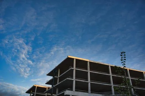 Concrete Building Frame Under Construction at Sunset Stock Photos