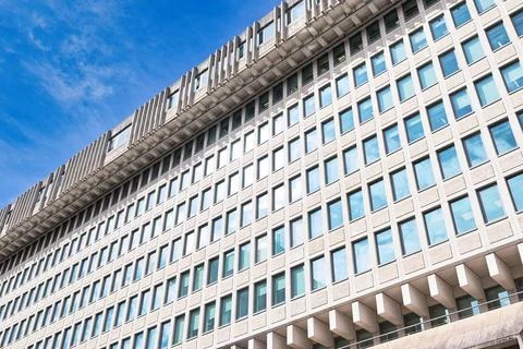 Concrete Building with Rectangular Windows and Blue Sky  in London, UK. Stock Photos