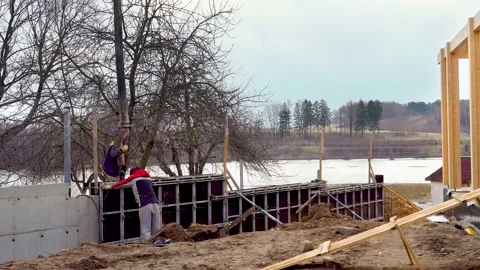 Concrete casting pump. Construction machinery works on building of wooden house Video stock 194003043