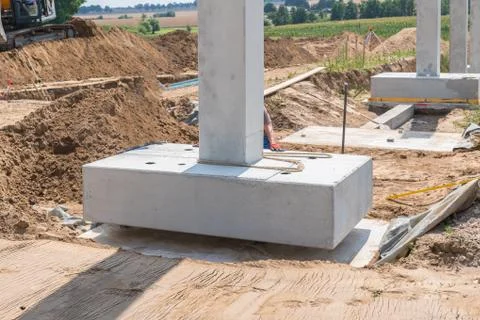 A concrete column is placed on a foundation Stock Photos