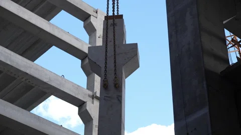 Concrete construction with crane lifting precast panel Stock Footage 315960768