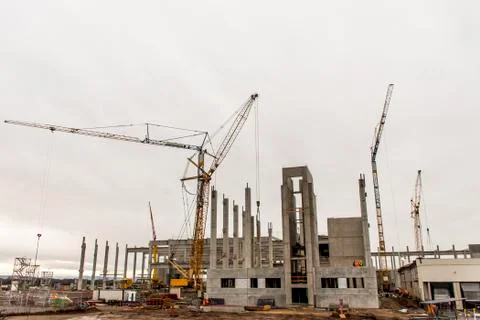 Concrete construction yard building site crane cloudy sky background Stock Photos