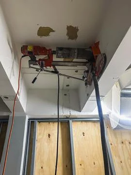Concrete core drilling work during building renovation project. Stock Photos