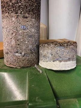 Concrete core sample extracted from reinforced concrete during core drillin.. Stock Photos