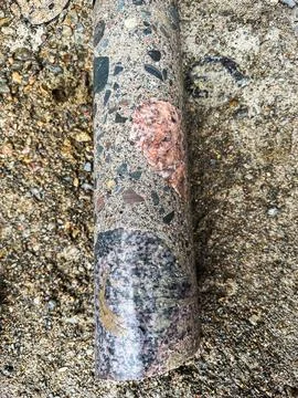 Concrete core sample extracted from reinforced structure. Stock Photos