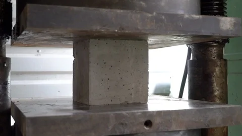 Concrete cube test. Concrete under pressure in hydraulic press. How strong Stock Footage 106949528