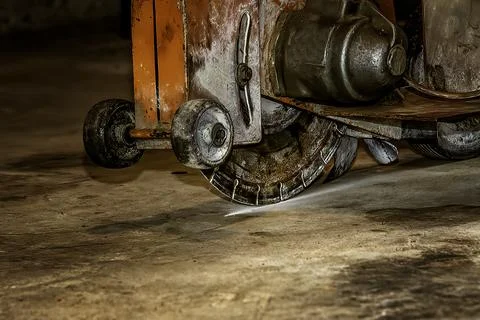 Concrete cutting machine making first cut Stock-Fotos