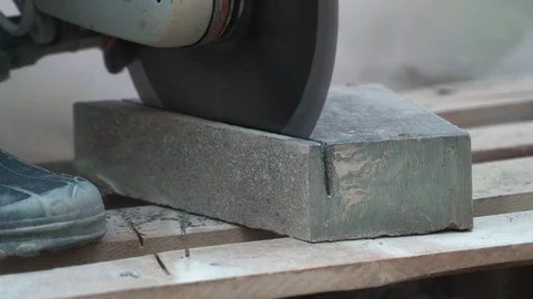 Concrete cutting machine. A worker in the park area cuts heavy slabs for a Video stock 120873209