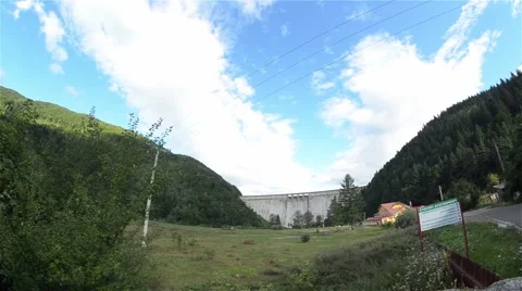 Concrete dam built between two mountain slopes and that close a artificial lake Stock Footage 60780428