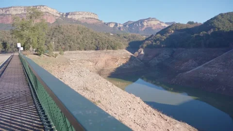 Concrete dam low level in Spain and drying up water during drought season. Stock Footage 265304962