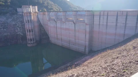 Concrete dam low level in Spain and drying up water during drought season. Stock Footage 265304985
