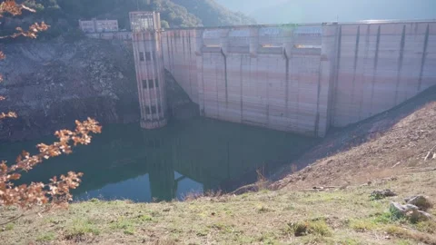 Concrete dam low level in Spain and drying up water during drought season. Stock Footage 265305113