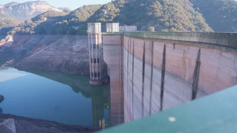 Concrete dam low level in Spain and drying up water during drought season. Stock Footage 265305264