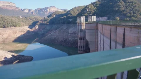 Concrete dam low level in Spain and drying up water during drought season. Stock Footage 265305269