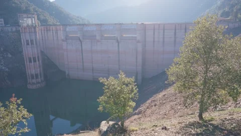 Concrete dam low level in Spain and drying up water during drought season. Stock Footage 265305279