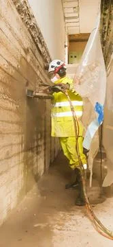 Concrete demolition work using professional construction equipment Stock Photos