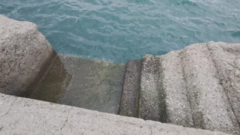 Concrete Dock Steps Leading Into Sea With Waves in Quiet Harbor Stock Footage 338104454
