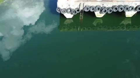 Concrete dock with white cloud reflection on surface in summer, aerial video Stock Footage 277587823