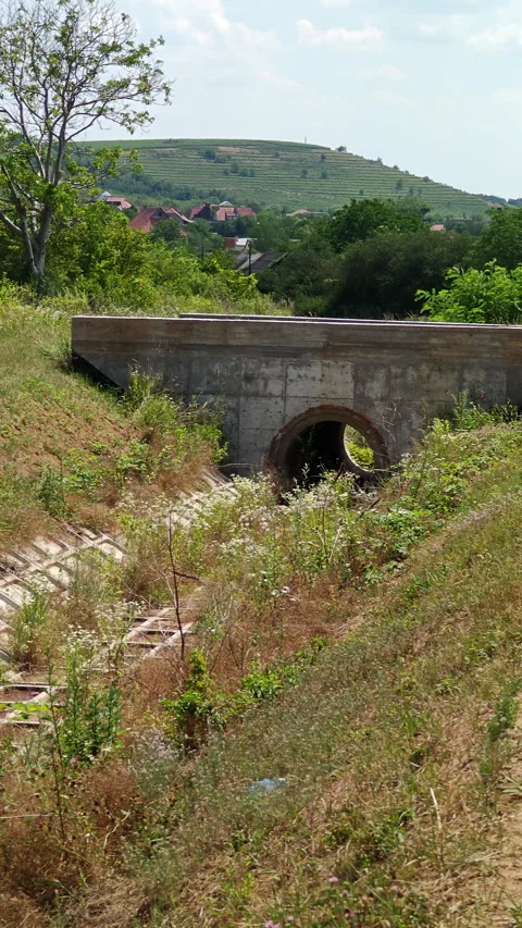 Concrete Drainage Culvert Pipe Under Road in Rural Landscape Stock Footage 337649356