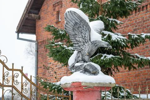 Concrete eagle covered in snow Stock Photos