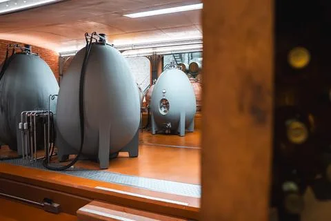 Concrete egg wine fermentation tanks inside a modern winery cellar Stock Photos