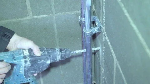 Concrete, electric drill,Close up hands hold electric drill in room, Video stock 86523434