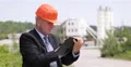 Concrete Factory Manager Inspecting Work Field and Taking Notes on Agenda Pages 4k or 4k+ Resolution