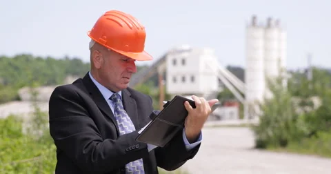 Concrete Factory Manager Inspecting Work Field and Taking Notes on Agenda Pages Stock Footage 68420723