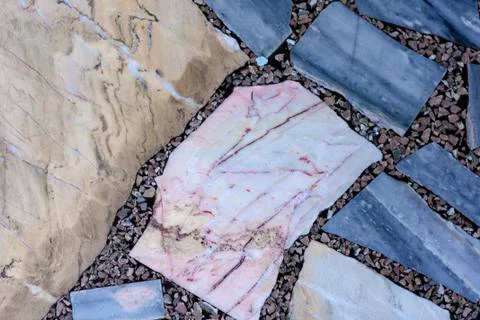 Concrete floor with multi-colored marble stone slabs background and texture Foto stock