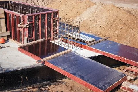 Concrete formwork is set up with rebar for a structural project at an industr Foto stock