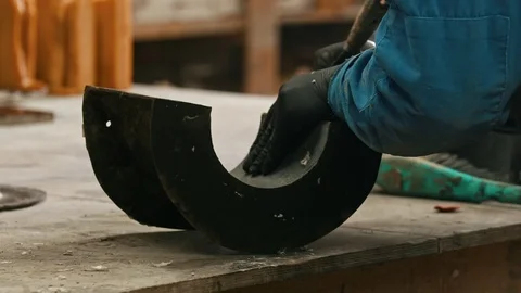 Concrete industry in the workshop - a man working with a chisel to clean up the Stock Footage 126266976