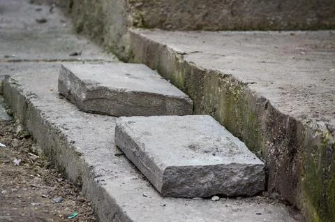 A concrete ledge with two additional bricks placed on it. Stock Photos