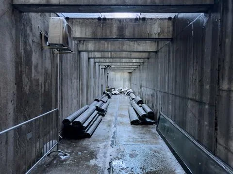 Concrete long rectangular tunnel with storage of building materials Stock Photos